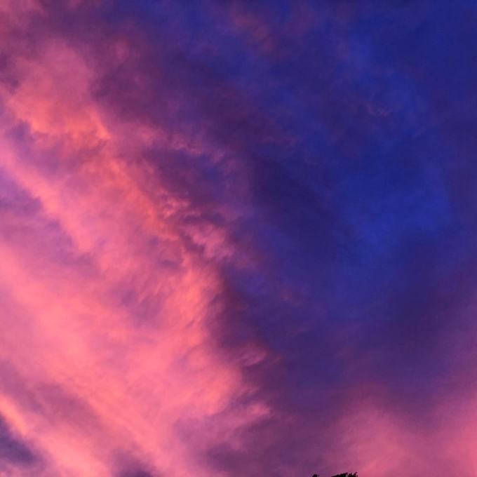 Dramatic blue, purple, salmon, coral, and pink clouds as the sunsets
